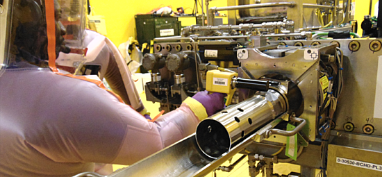 Worker performing maintenance on nuclear equipment Ontario Nuclear Services Facility