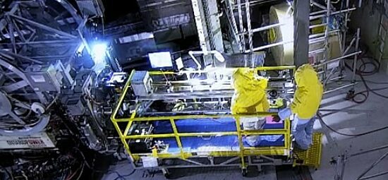 Two CWEST technicians standing on a sample retrieval cart