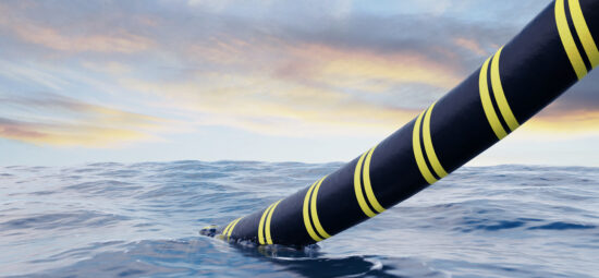 Large subsea cable exiting an ocean