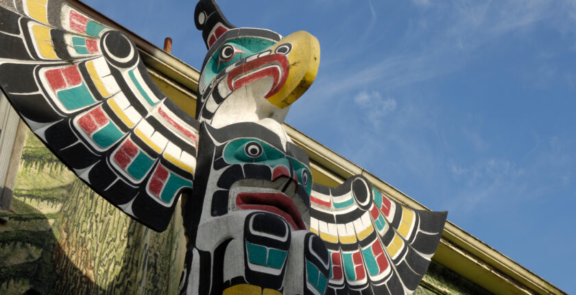 Outdoor photograph of a tall totem pole