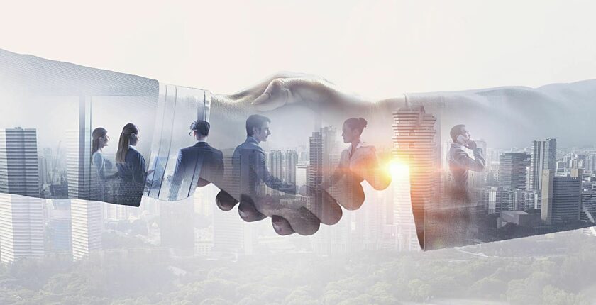 Stylized art of workers in business meetings overlayed by a closeup handshake