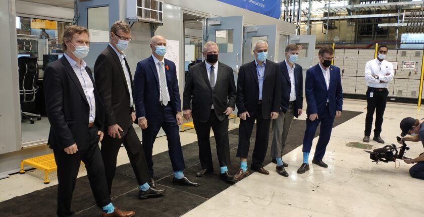 Industry representatives showing off commemorative socks at the GridSim grand opening
