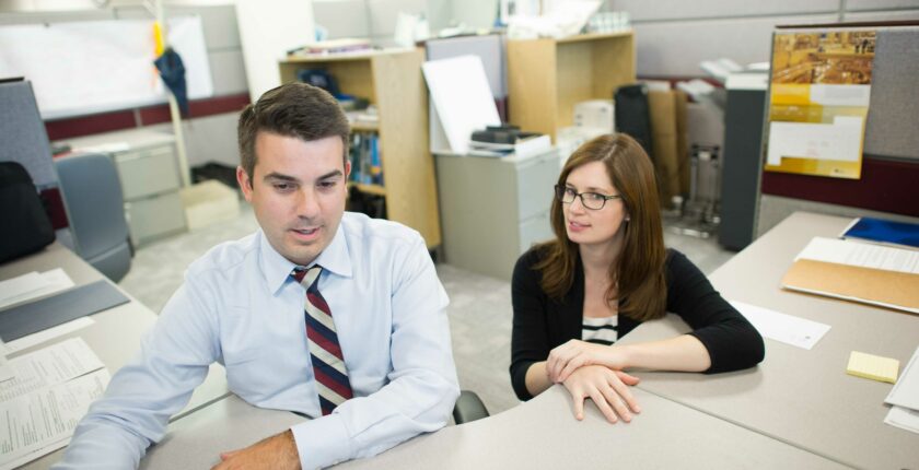 Workers holding a conversation in an office setting