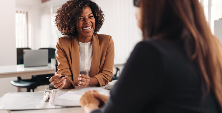 Office worker engaged in friendly conversation with co-worker