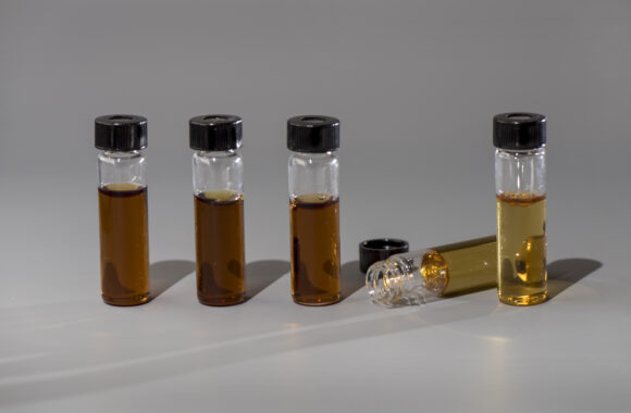 Photograph of five vials filled with self-healing fluid
