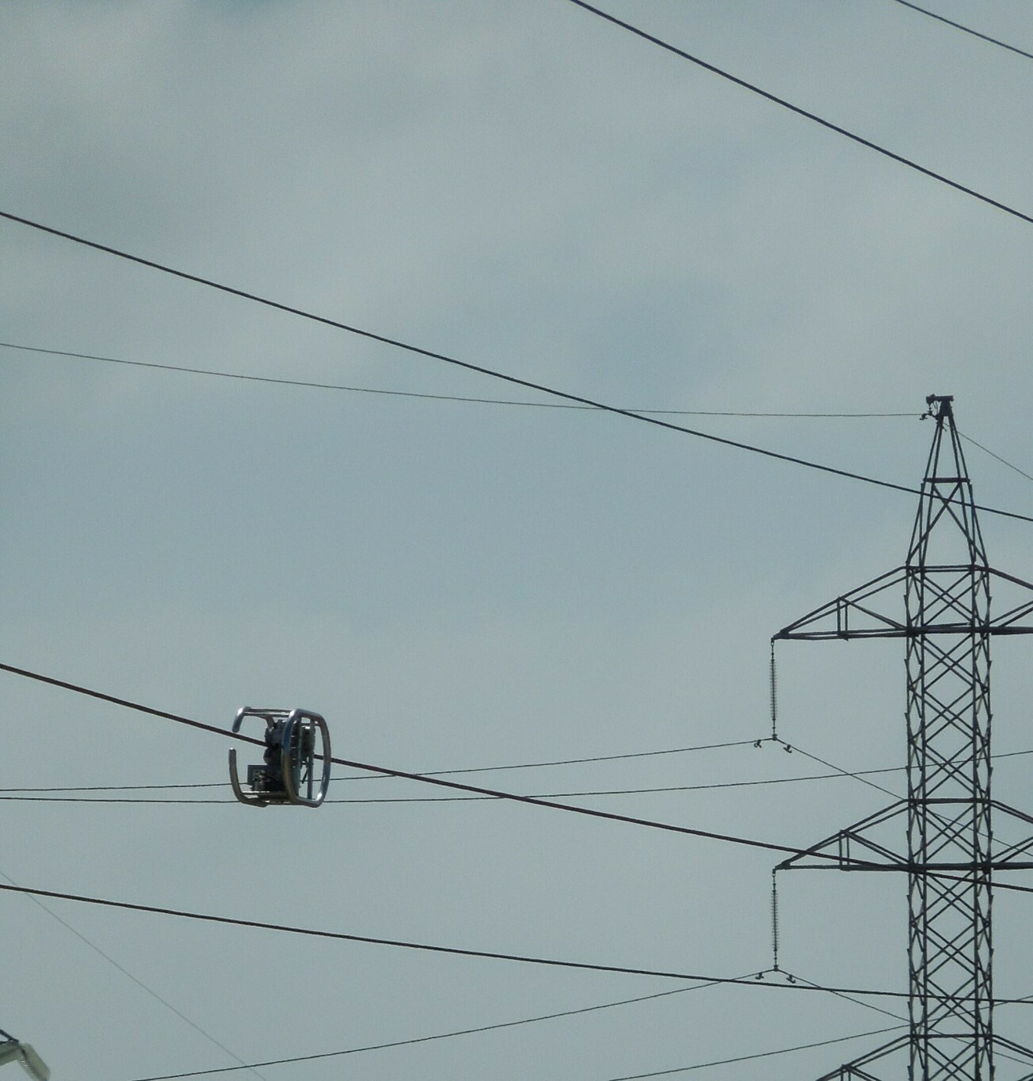 Outdoor photograph of a LineVue unit inspecting a live transmission cable