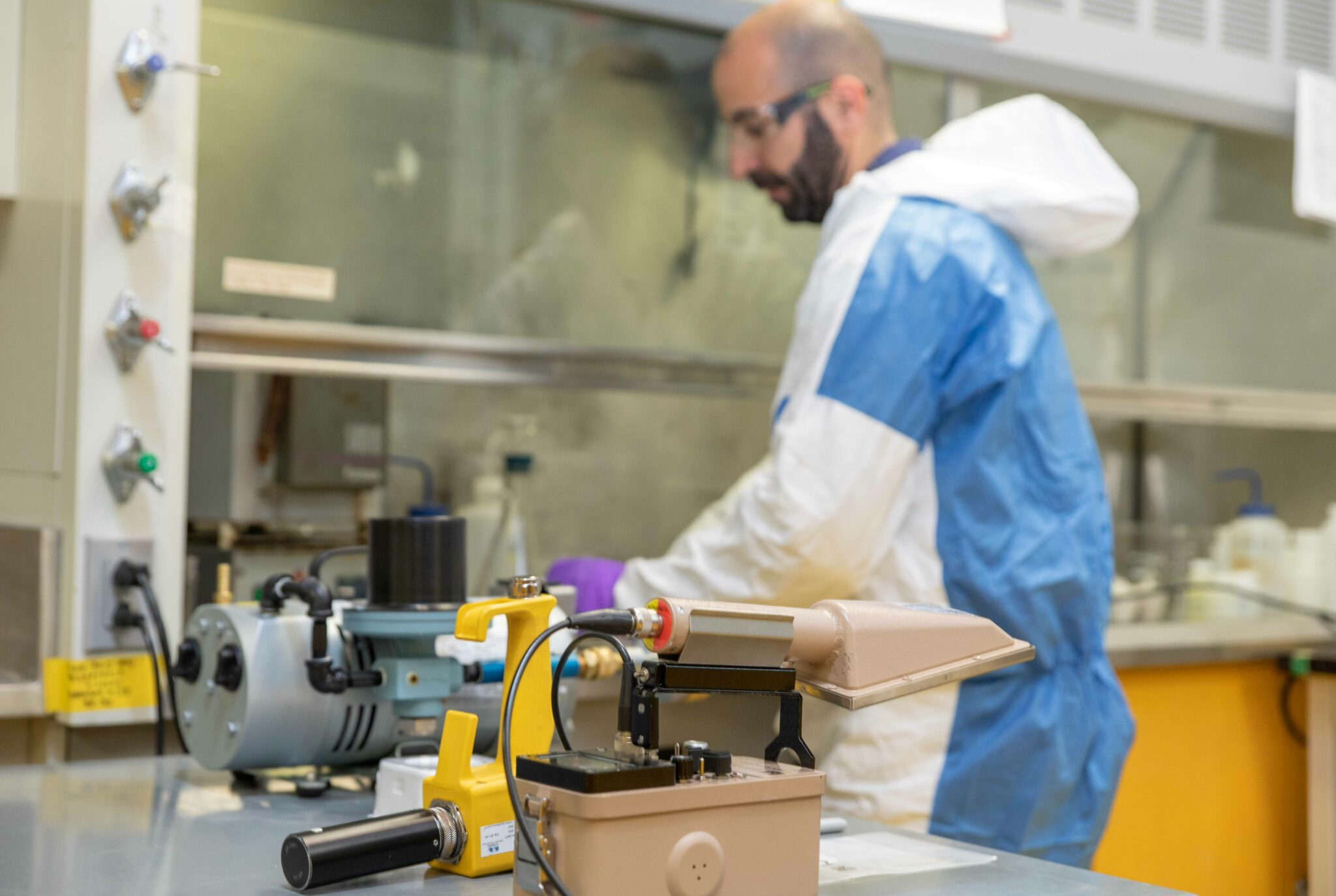 Worker maintaining inspection tools at workbench