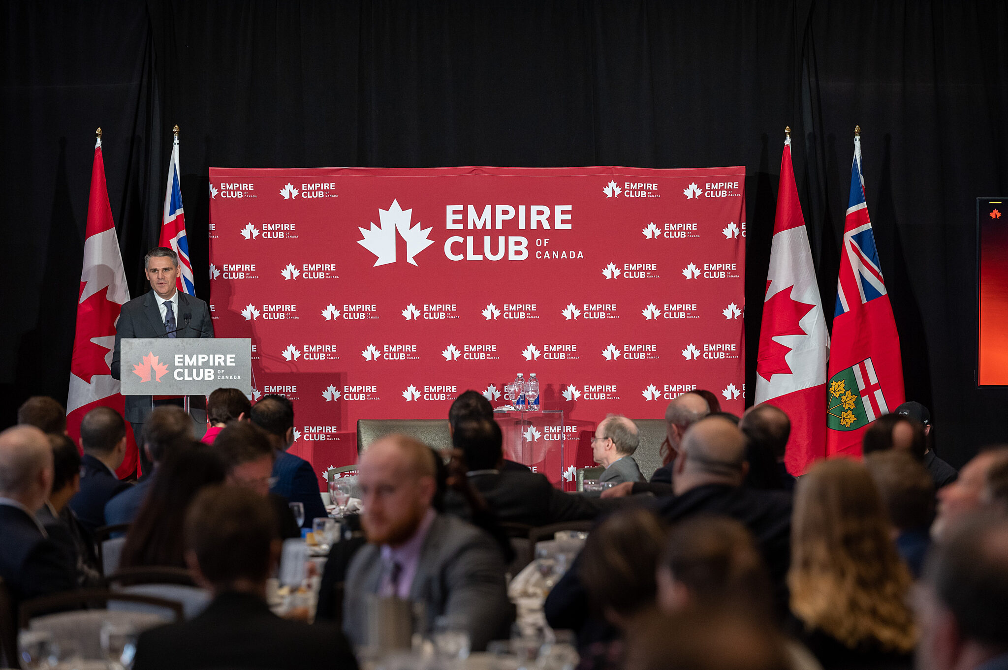 Representative at podium during Isotopes for Hope event