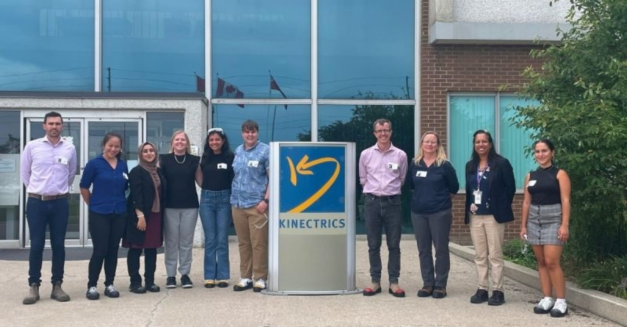 Tour group standing outside the Kinectrics headquarters entrance