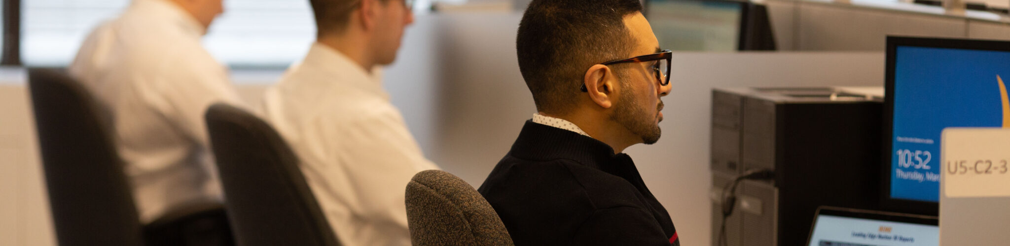 An open office with workers at their stations.